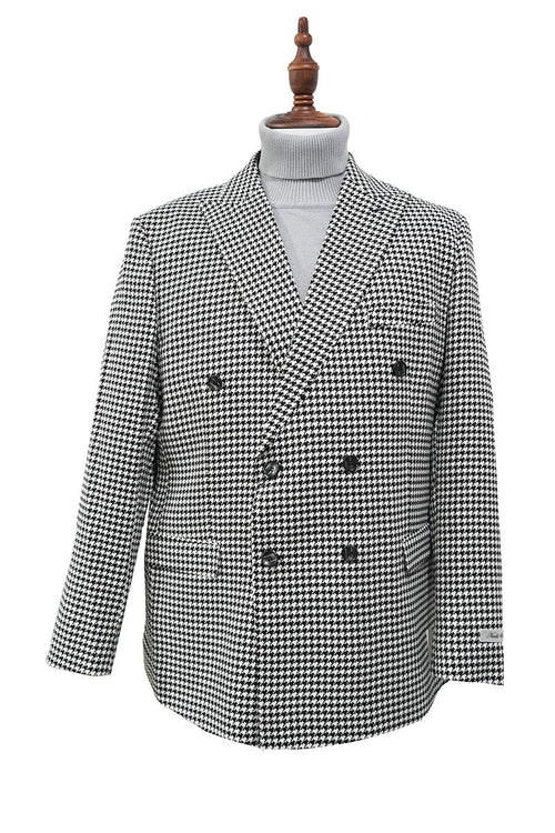 Black houndstooth double-breasted jacket with structured silhouette. Wide lapels, front pockets, and six decorative buttons. Long, slightly tapered sleeves with contrasting cuffs. Fully lined. Bold black and white houndstooth pattern.
