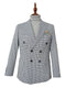 Blue houndstooth double-breasted jacket with structured fit. Features broad lapels, fitted silhouette, and buttoned cuffs. Includes a patch pocket with a multicolored design. Tailored, formal aesthetic.
