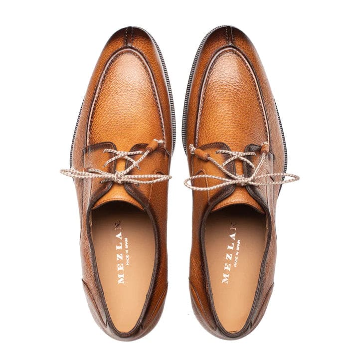 Mezlan's Fratello cognac deerskin lace-up shoes. Split-toe design with a rounded shape, crafted from smooth cognac deerskin. Minimalist lace-up system, light interior lining, and a dark outsole.
