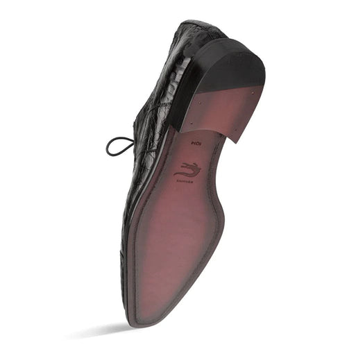 Mezlan's Giovane derby in black crocodile: cap-toe, pointed shape, sleek lines. Black lace, leather sole with burgundy bottom. Small heel. Distinct crocodile scale pattern.
