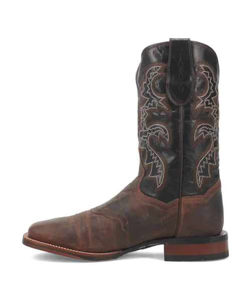Dan Post Men's Franklin Boot: Dark brown leather, pointed toe, slight heel. Tall shaft with intricate stitching and stylized ankle patterns. Contrasting, structured sole.
