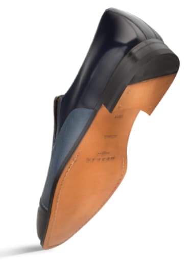 Blue calfskin/deerskin slip-on dress shoe. Sleek, streamlined silhouette with a pointed toe. Tan leather outsole with dark heel detailing.
