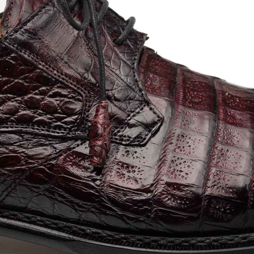 Mezlan men's burgundy crocodile cap-toe derby shoes. Textured burgundy crocodile leather upper, structured silhouette, black laces. Formal, high-quality construction with shiny finish. Distinctive scale pattern.
