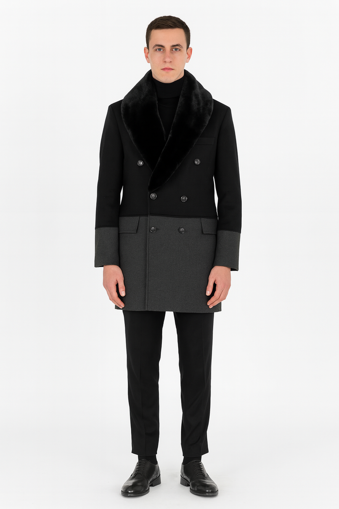 Men's double-breasted wool overcoat with faux fur shawl collar. Black and charcoal grey color-blocked design. Tailored silhouette, slightly relaxed fit.
