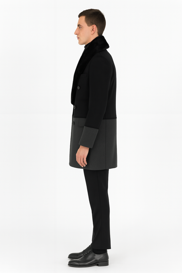 Men's double-breasted wool overcoat. Black upper, grey bottom, faux fur shawl collar, and contrasting cuff details. Structured with two rows of buttons.
