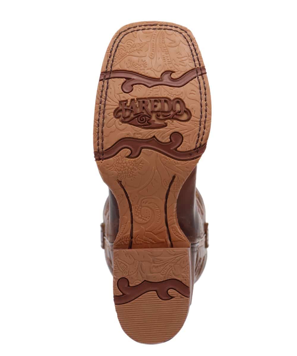 Laredo Dream Weaver boot. Brown, textured leather upper with embossed floral patterns. Tan sole with decorative design and brand logo.
