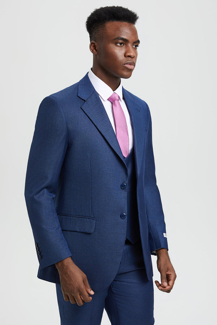 Men's blue sharkskin Stacy Adams suit: 2-button, fitted design. Structured blazer with notched lapel, side pockets. Deep blue with dark buttons. Matching vest. Smooth, subtly shiny fabric for a tailored look.
