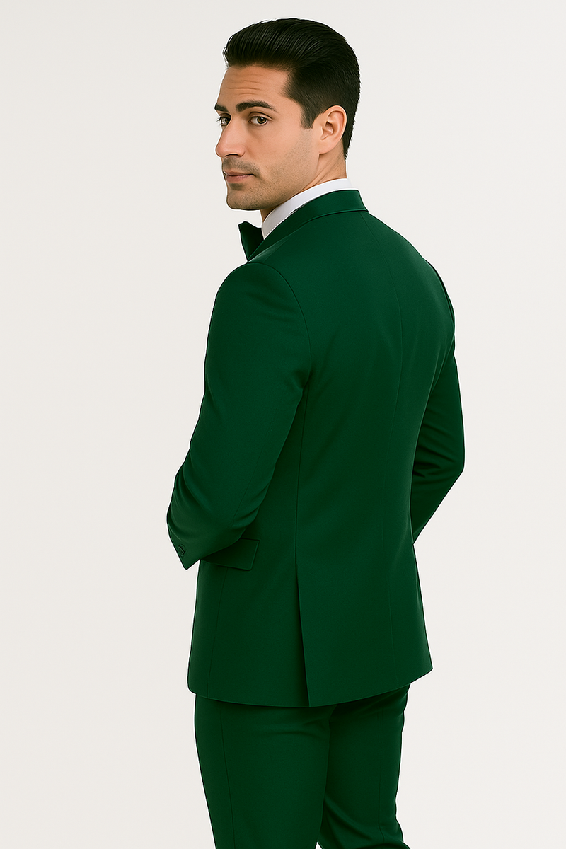 Emerald green tuxedo set: tailored blazer with structured fit, peak lapels, and single-button closure. Includes matching fitted trousers. Four-piece ensemble. Smooth finish.
