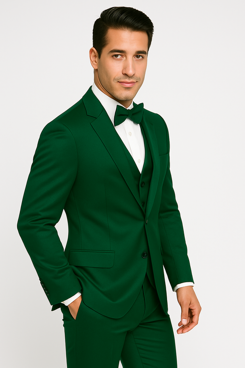 Emerald green tuxedo set: tailored jacket with notched lapel, matching vest and trousers. Includes white shirt, black bow tie. Smooth, fitted, streamlined silhouette. Vibrant color.
