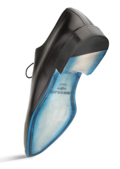 Mezlan's Enterprise balmoral in black calfskin. Smooth, sleek black leather upper with a curved design. Contrasting blue sole trim. Rounded toe, structured heel, and lace-up closure for a formal look.
