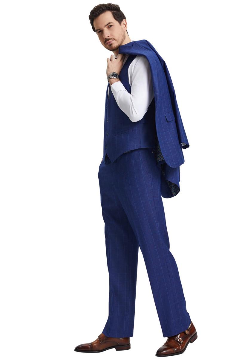Men's Stacy Adams suit: blue, peak lapel, windowpane plaid. Includes matching scoop neck vest. Tailored, slim-fit pants. Jacket draped over shoulder.
