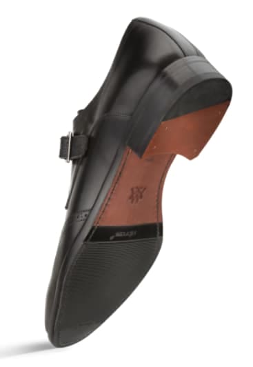 Black Wing Tip Oxford shoe in smooth black leather. Pointed toe, wingtip brogue detailing, and a low stacked heel. Curved sole for stability.
