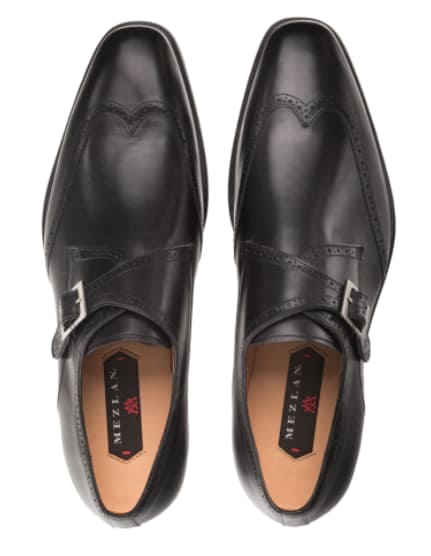 Men's Forest black wingtip oxfords: smooth black leather, rounded toe, decorative stitching & perforations. Side buckle detail. Flat sole. Stylish & refined.
