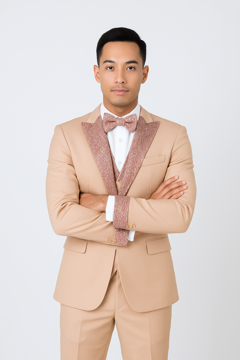 Champagne rose gold prom tuxedo for men. Tailored jacket with sparkling lapel/bow tie, paired with white shirt and contrasting cuffs. Matching trousers complete the elegant look.
