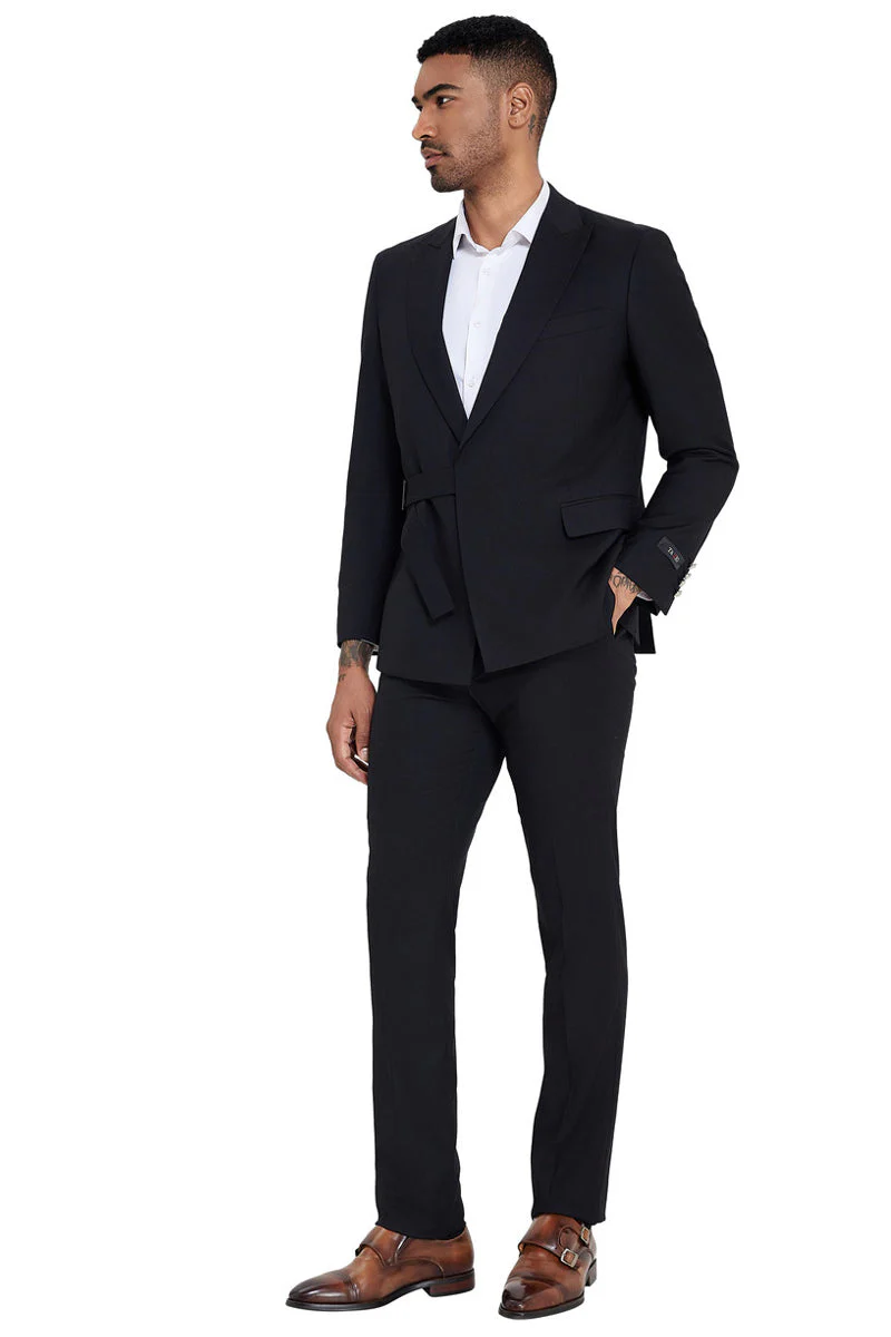 Men's black slim-fit suit. French front, peak lapel, single strap detail. Tailored jacket, two front pockets. Streamlined trousers. Solid black fabric, formal, fitted design.
