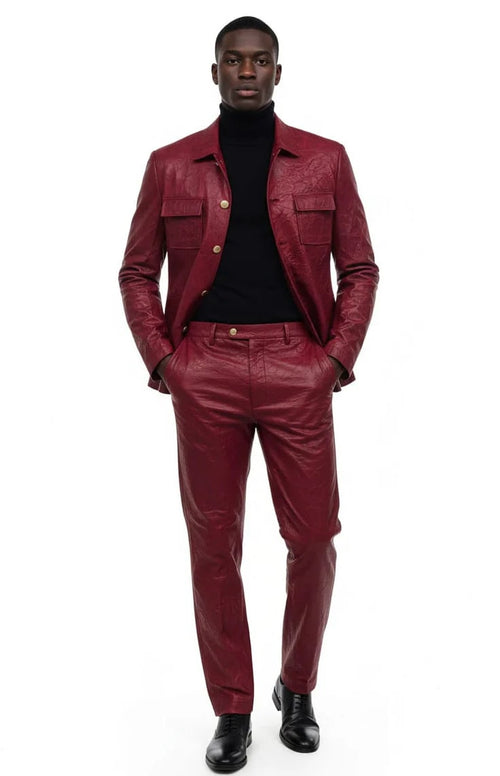 Burgundy faux leather two-piece suit with textured finish. Slim fit jacket features two chest pockets and single-button closure. Matching slim trousers complete the look.
