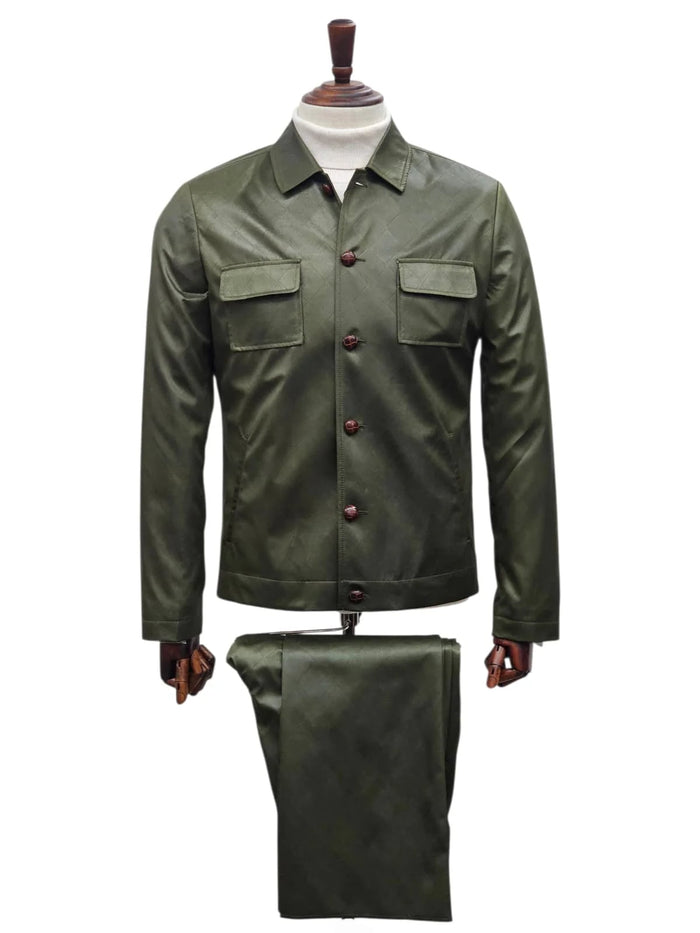 Olive green men's slim fit faux leather suit. Includes button-up shirt with front pockets, collared neckline, and matching trousers. Smooth, glossy finish with brown buttons.
