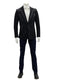 Black slim-fit suit with notch lapels, structured shoulders, and zippered pockets. Minimalist design. Worn with a white shirt and navy trousers. Tailored silhouette.
