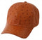 Genuine ostrich leather cap. Rich brown color, textured with characteristic bumps. Rounded crown, curved visor. Seamless design, smooth exterior, no visible stitching.
