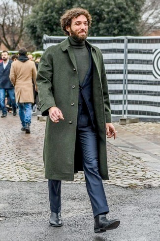 Men's olive wool overcoat, tailored knee-length, buttoned front, wide lapels. Styled with dark turtleneck and pants. Classic, sophisticated look.
