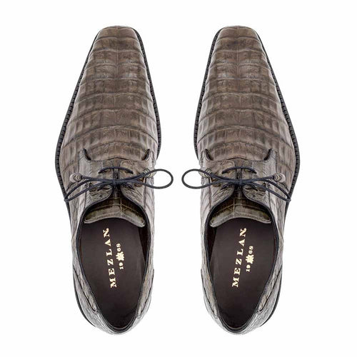 Mezlan Anderson men's shoes: Grey genuine crocodile lace-ups with elongated, tapered shape and textured finish. Classic lace-up design, rounded toe, varying grey tones, and black insoles with gold lettering.

