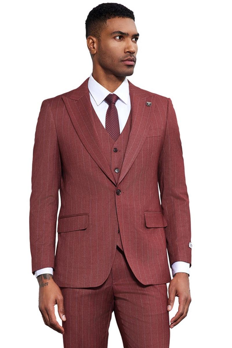 Men's Stacy Adams vested suit: burgundy with thin pinstripes. Features a fitted, one-button jacket with peak lapels, pockets, and a matching vest. Textured fabric creates a structured look. Includes white shirt & patterned tie.
