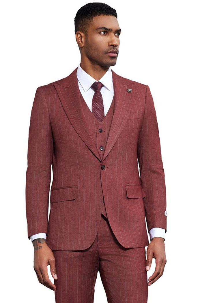 Men's Stacy Adams vested suit: burgundy with thin pinstripes. Features a fitted, one-button jacket with peak lapels, pockets, and a matching vest. Textured fabric creates a structured look. Includes white shirt & patterned tie.
