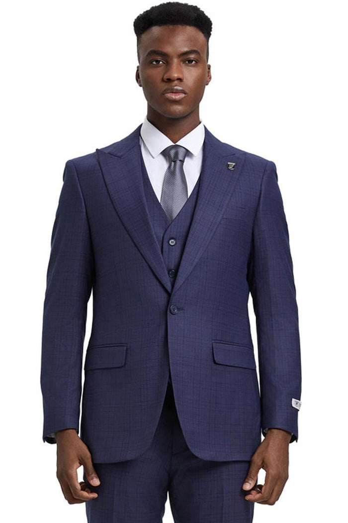Stacy Adams men's suit in eggplant purple windowpane plaid. Features a fitted silhouette, one-button closure, wide peak lapels, and a matching vest. Trousers complete the set.
