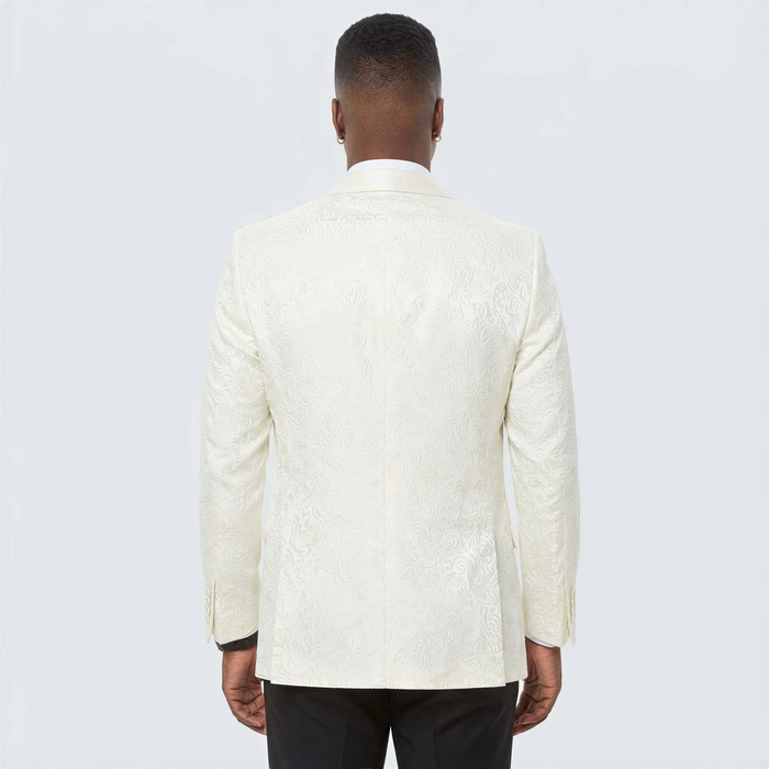Ivory paisley tuxedo jacket by Alberto Nardoni. Textured paisley pattern, structured silhouette, single rear vent. Smooth, shiny fabric for a formal look.
