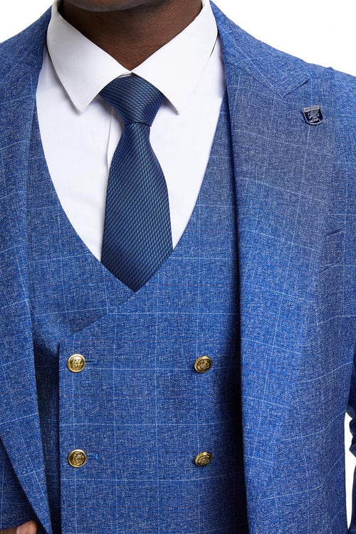 Men's Stacy Adams suit with peak lapels, double-breasted vest, and windowpane plaid. Blue with structured collar, fitted shape, and gold buttons. Includes a dark blue tie with a subtle check.
