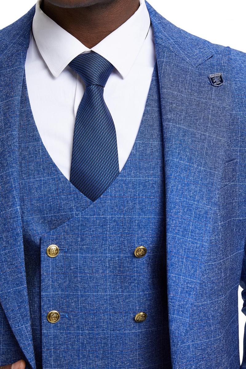 Men's Stacy Adams suit with peak lapels, double-breasted vest, and windowpane plaid. Blue with structured collar, fitted shape, and gold buttons. Includes a dark blue tie with a subtle check.
