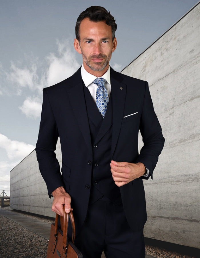 Men's slim-fit wool suit with a double-breasted navy vest. Jacket: single-breasted, structured shoulders. Vest: buttoned. Fabric: smooth wool. Sleek, tailored design.
