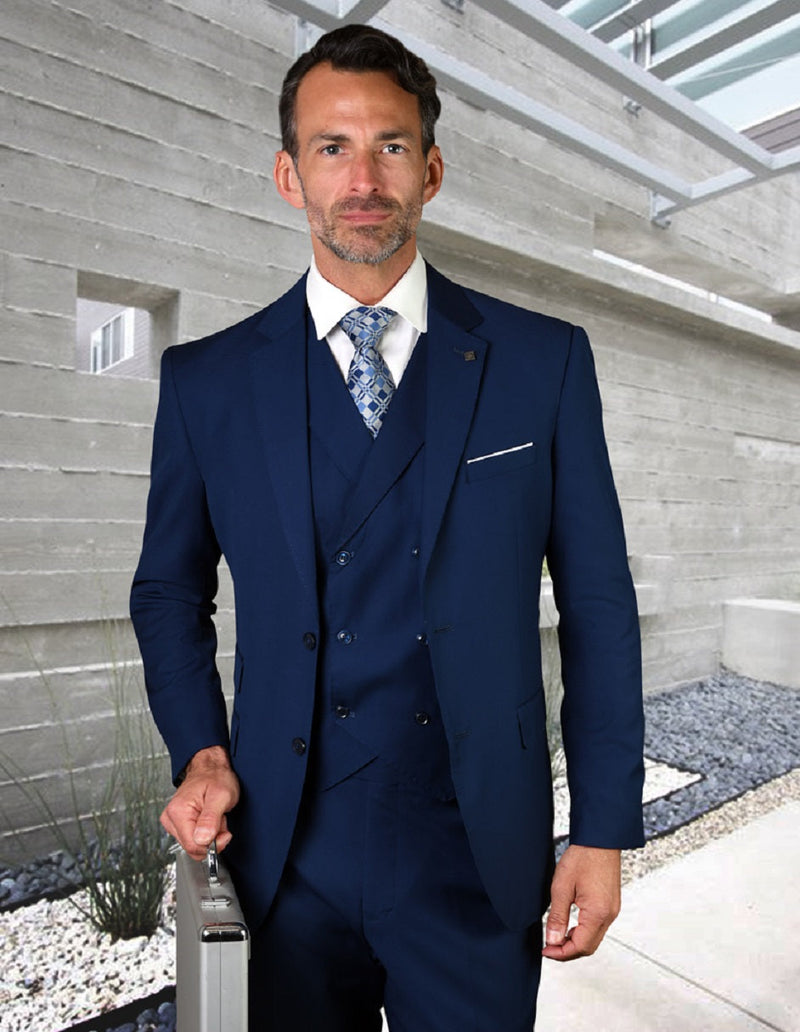 Men's slim fit wool suit in sapphire blue. Includes a single-breasted jacket with notched lapels and matching trousers. Features a double-breasted vest. Smooth, patternless fabric. Seamless design.
