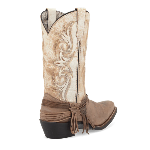 Laredo Myra women's boot: tall, pointed toe. Light beige upper with swirling stitch detail. Dark tan lower section. Ankle tie detail. Black sole.
