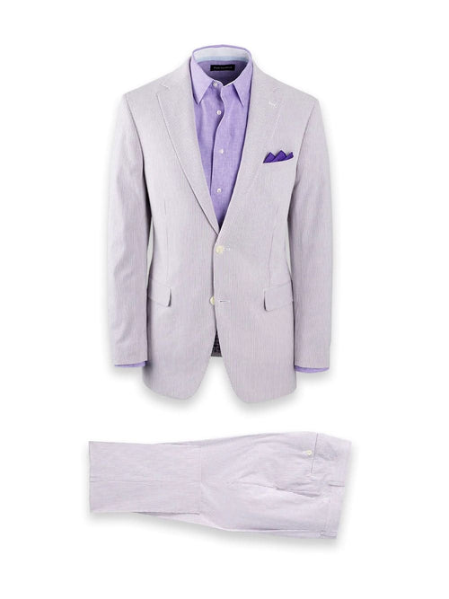 Men's lavender seersucker suit: cotton blazer & trousers. Striped light lavender/white pattern. Blazer: 2 buttons, notch lapel, 2 pockets. Trousers: straight leg, single back pocket.