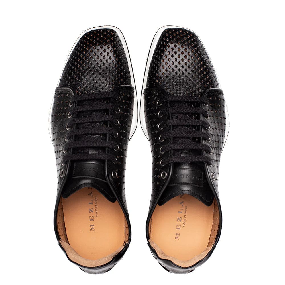 Mezlan Luce black leather sneakers: rounded toe, smooth upper with perforations. Primarily black, white rubber sole. Black laces/eyelets. Light-colored interior lining. Stylish & ventilated.
