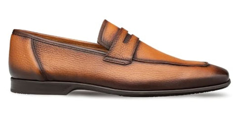 Cognac deerskin penny loafers with a rounded toe, penny slot, and textured upper. Featuring a streamlined shape and a flat leather sole with a slight heel.
