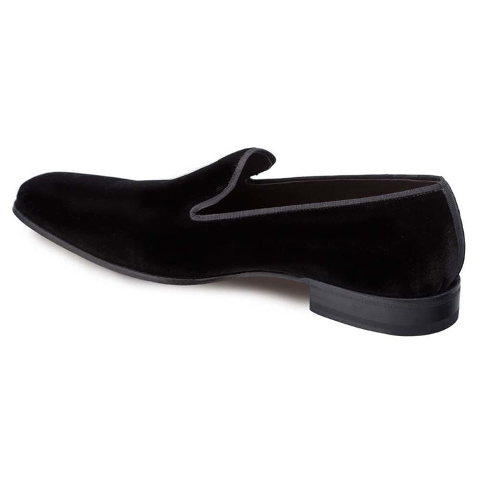 Mezlan Lublin slip-on: Sleek black velvet formal shoe with a rounded toe and low profile. Features subtle edge trim and a slim black rubber sole. Soft texture, elegant design.
