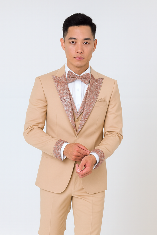 Men's champagne rose gold prom tuxedo: Four-piece outfit includes a beige jacket with sparkly rose gold details, white shirt, matching bow tie, and tailored pants.

