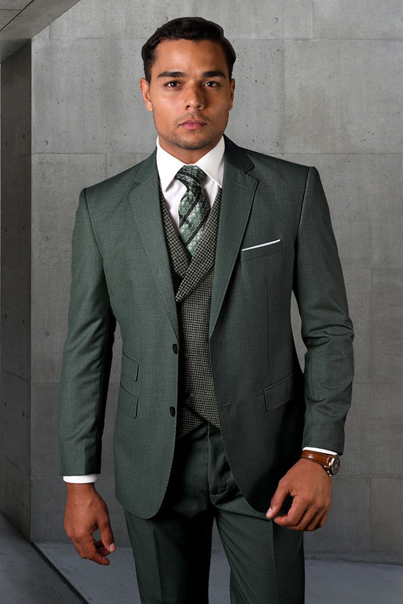 Hunter green two-button wool suit with micro plaid vest. Tailored fit, structured shoulders, flat-front pants. White shirt, patterned tie. Formal design, front pockets, chest pocket.
