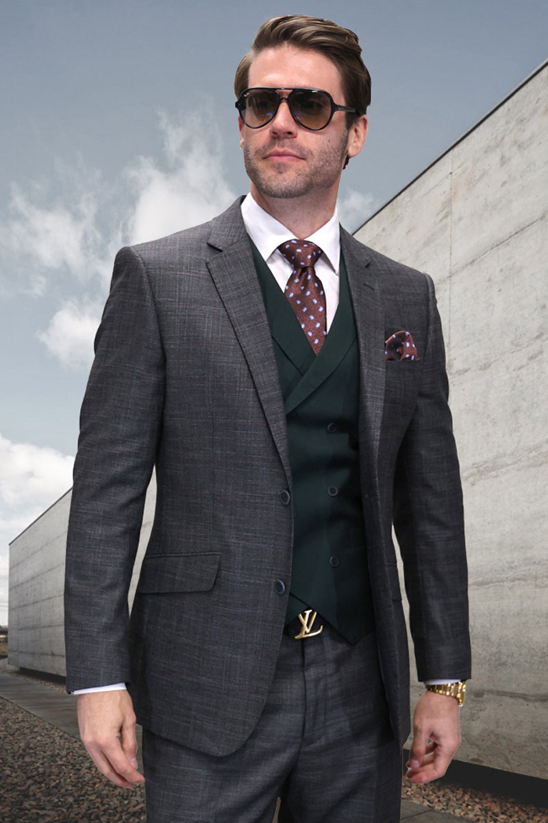 Hunter green wool designer suit with double-breasted vest, structured fit, sharp lapels, and button closures. Features a tailored design with subtle sheen. Includes contrasting patterned tie and pocket square in brown tones.
