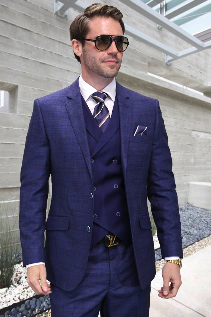 Sapphire blue sharkskin suit: double-breasted vest, structured blazer, flat-front trousers. Tailored modern fit. Textured fabric.
