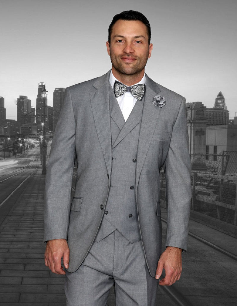 Men's grey 2-button suit with double-breasted vest. Features a tailored fit, pleated trousers, and sharp lines. Includes pointed collar shirt, bow tie, and lapel flower for a coordinated, classic look.