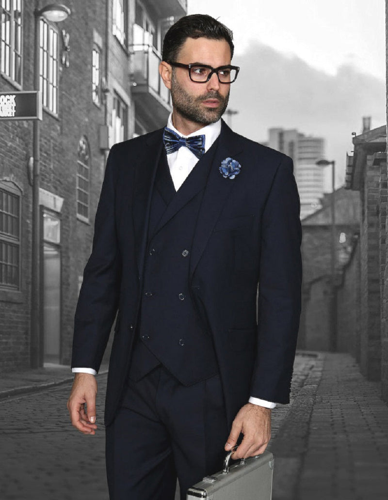 Men's navy suit with pleated pants, classic fit. Includes a double-breasted vest. Tailored with structured shoulders and a fitted waist. 
