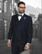 Men's navy suit with pleated pants, classic fit. Includes a double-breasted vest. Tailored with structured shoulders and a fitted waist. 
