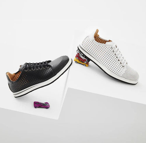 Mezlan's Luce men's sneakers: Black perforated leather upper, rounded toe, flat laces, and white rubber sole. Minimal stitching with a smooth leather lining.
