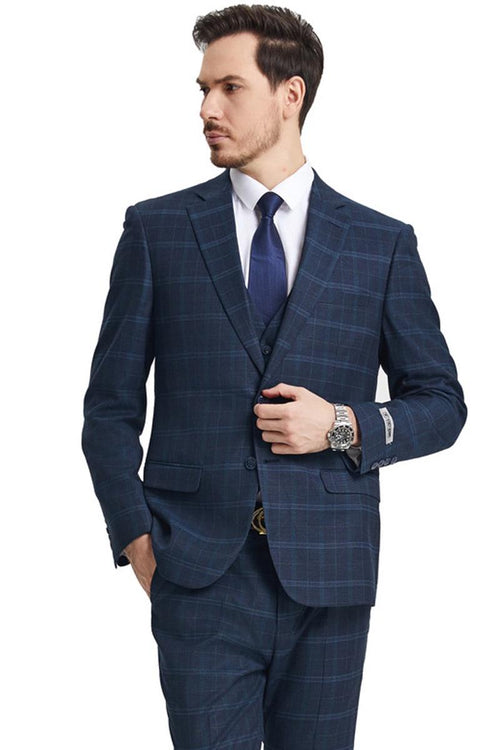 The navy blue Stacy Adams vested modern fit suit features a windowpane plaid pattern, structured with a fitted blazer and matching trousers. The blazer has two front pockets and a notch lapel.