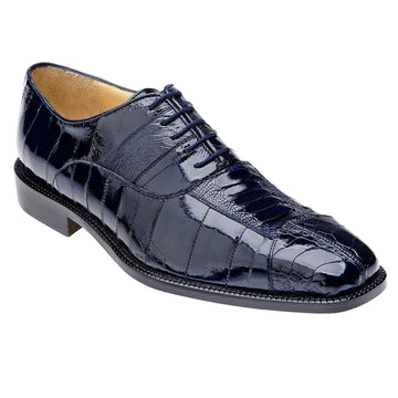 Navy Belvedere dress shoe. Ostrich leg & eel skin texture, pointed toe. Shiny navy leather, lace-up, slight heel. Smooth lining, subtle grain pattern.
