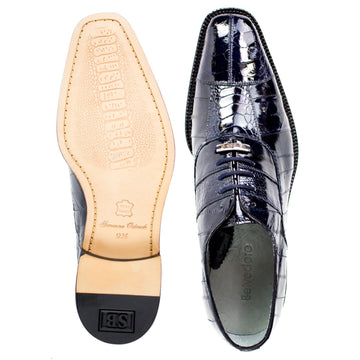 Navy ostrich leg and eel skin Belvedere Mare dress shoe. Pointed toe. Tan leather sole with textured pattern and branding.
