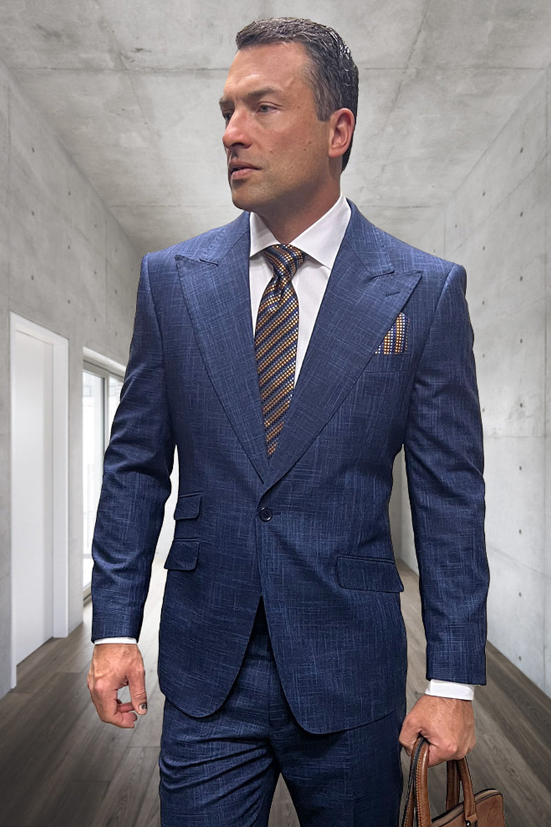 Indigo blue plaid wool suit. Tailored fit, peak lapels, single-button closure, structured shoulders. Flat front trousers. Textured plaid pattern. Includes contrasting tie and pocket square.
